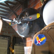 The empty gaze of a WW2 pilot's dress uniform gives the engine of the T6 trainer plane one last inspection.