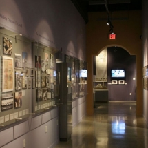 Even this narrow hallway became exhibit display space. Custom wall displays, designed by AST, showcase various historical photos.