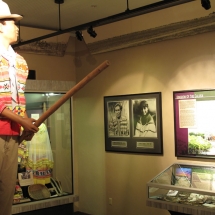 A Seminole glides through the Native People's Room standing atop his dugout canoe.