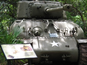 The positioning of an outdoor sign can be impactful. You cannot read this graphic without staring down the "business end" of a Sherman Tank.